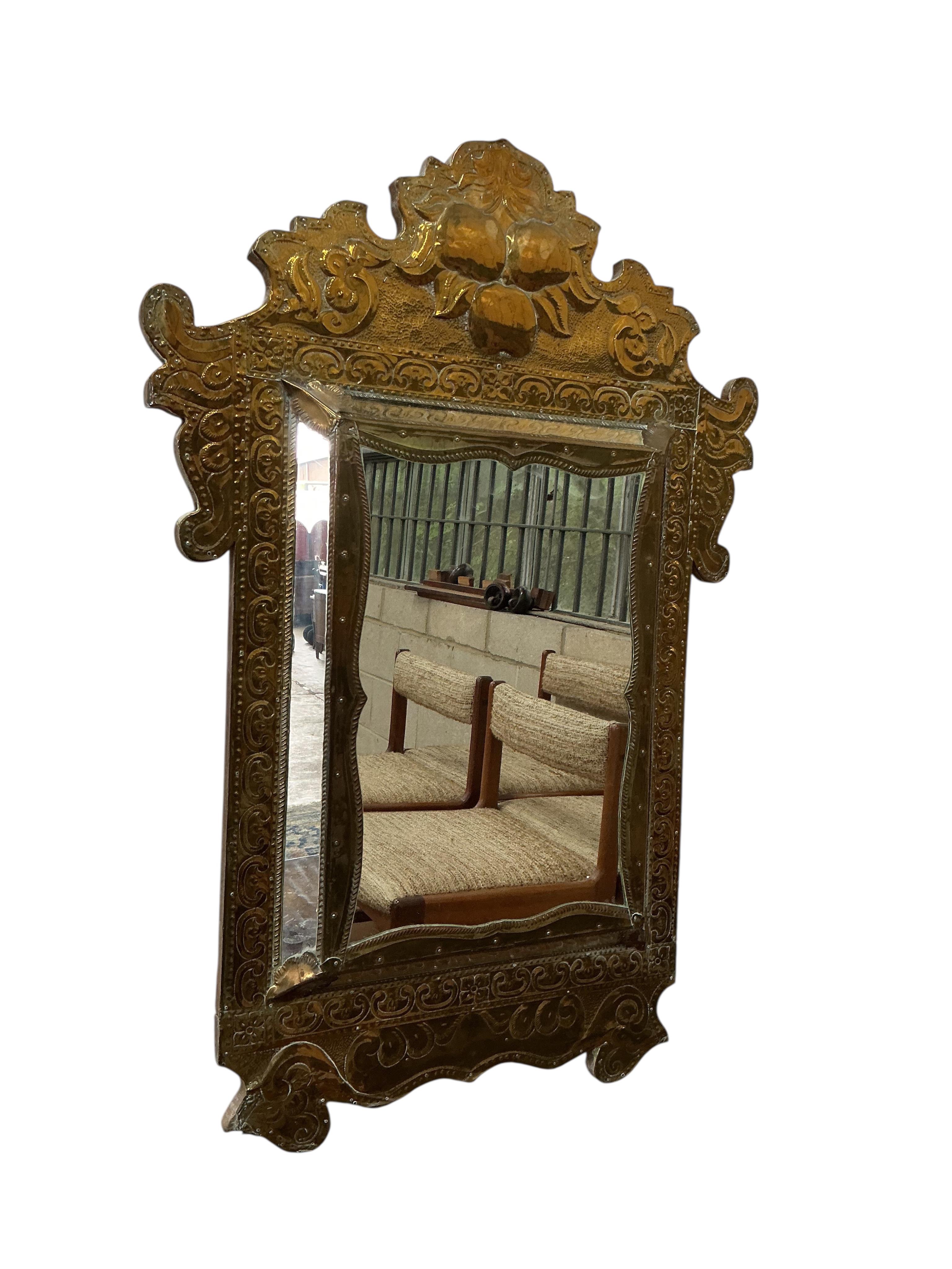 A pair of Eastern embossed brass wall mirrors, width 57cm, height 82cm